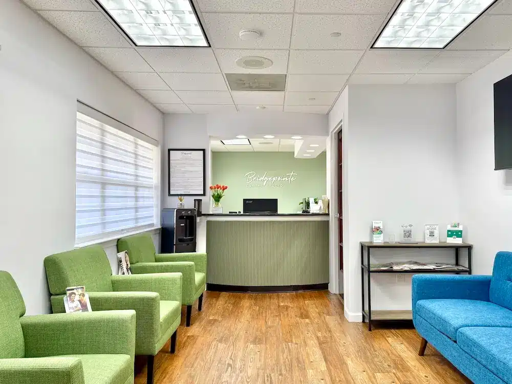 Modern dental office waiting room at Bridgepointe Dental Studio in Metuchen NJ with comfortable seating and clean design